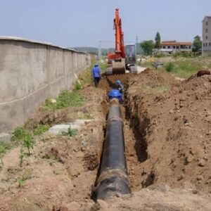 Construction team installing PE pipes for municipal underground pipeline renovation
