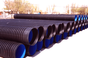 Workers inspecting white PVC pipes on a production line in a Chinese factory, quality control for export orders.